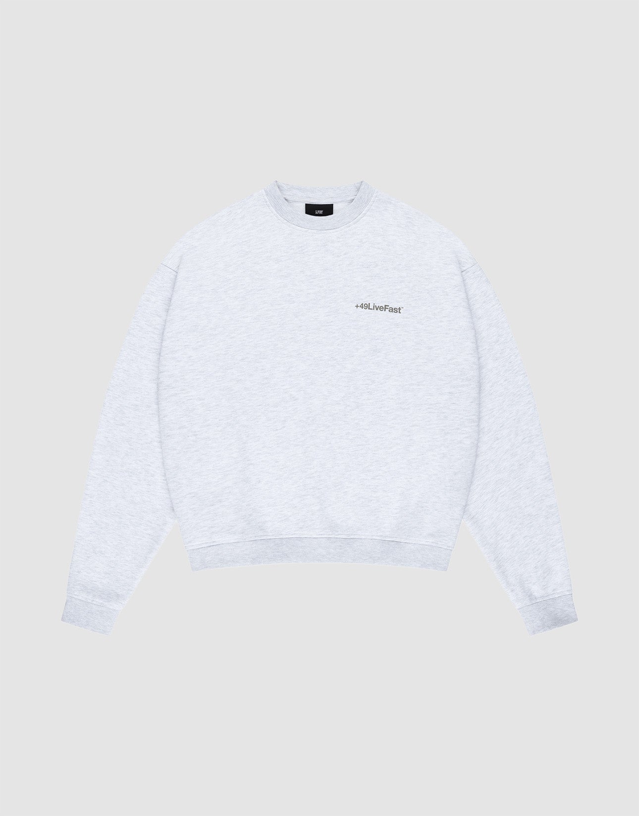 The LIVE FAST DIE YOUNG Basic +49 Chest Sweater is a light gray oversized crewneck with long sleeves and a small chestprint logo on the left, shown against a plain light gray background. | plain
