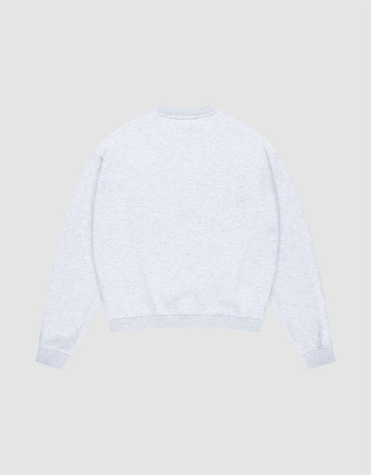 The LIVE FAST DIE YOUNG Basic +49 Chest Sweater is shown flat, back side up, against a light gray background. This oversized crewneck sweatshirt is made from soft Baumwolle and features long sleeves with ribbed cuffs and hem.
