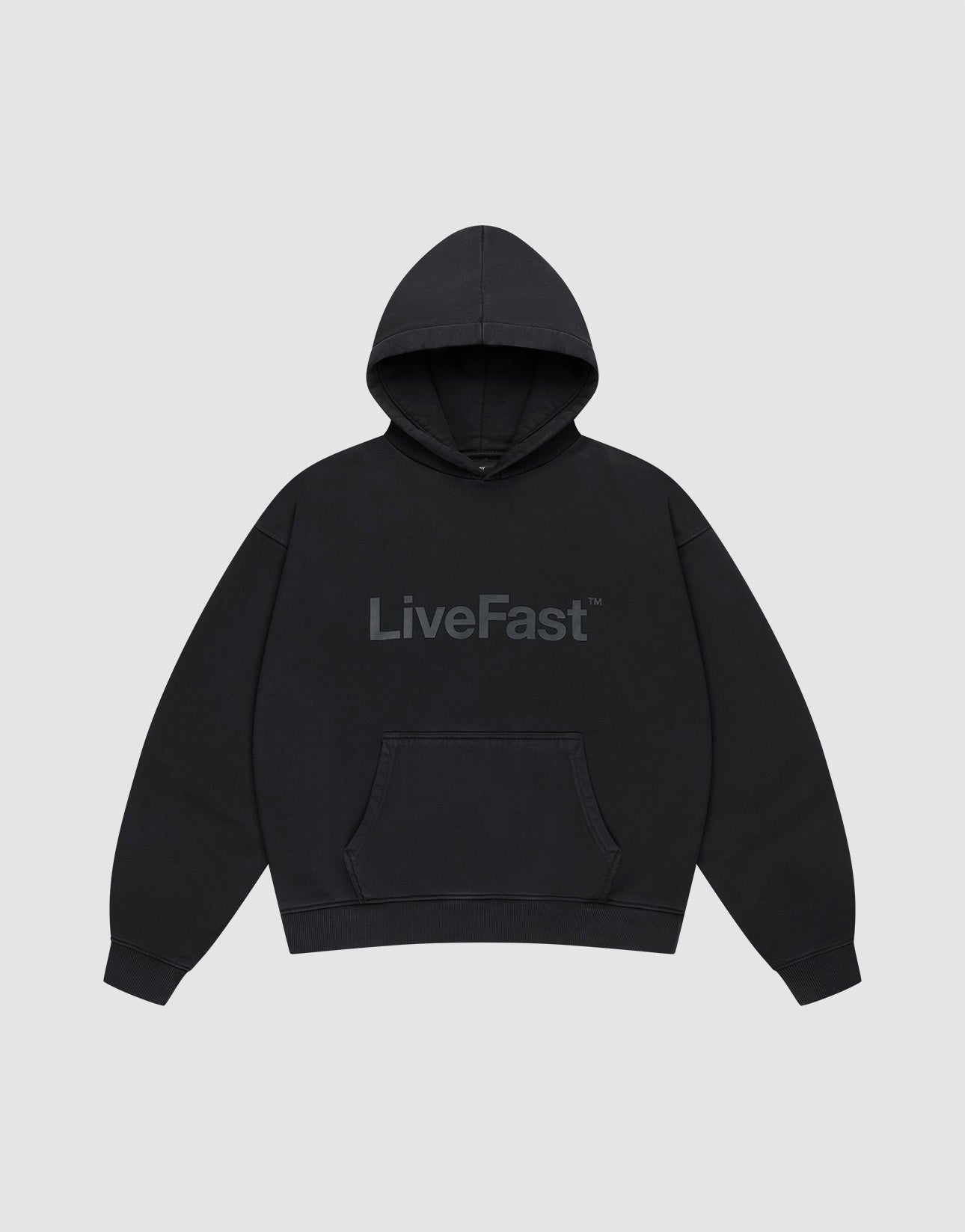The Basic Livefast Hooded by LIVE FAST DIE YOUNG is an oversized black hoodie featuring a subtle "LiveFast" front print, crafted from soft cotton and shown against a plain light gray background. | plain