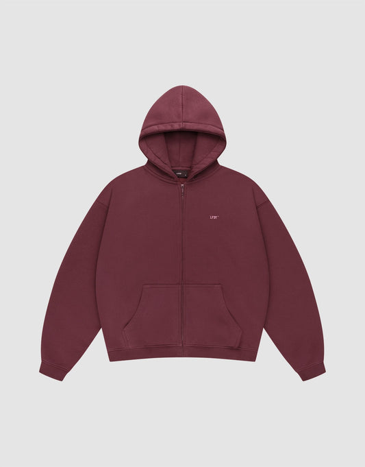 The Basic Hooded Zip by LIVE FAST DIE YOUNG is a maroon zip-up hoodie with a hood, front pockets, and small white LFDY branding on the left chest, shown on a plain light gray background. | plain