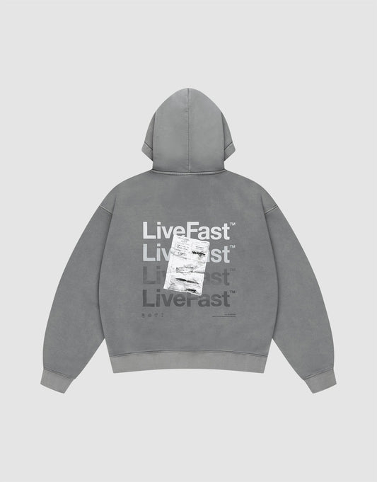 The Basic Evidence Hooded by LIVE FAST DIE YOUNG features an oversize fit, faded gray fabric, and bold “Live Fast” prints in white and gray on the back, with a shipping label graphic. The background is plain light gray. | plain