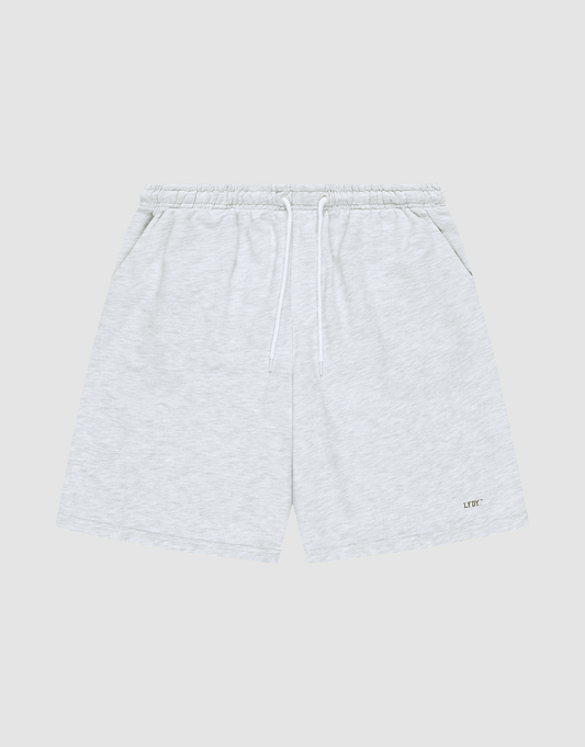LIVE FAST DIE YOUNG Basic Shorts in light gray feature a logo-print on the lower left leg, elastic waistband with white drawstring, side pockets, and a regular fit. Displayed on a plain gray background. | plain