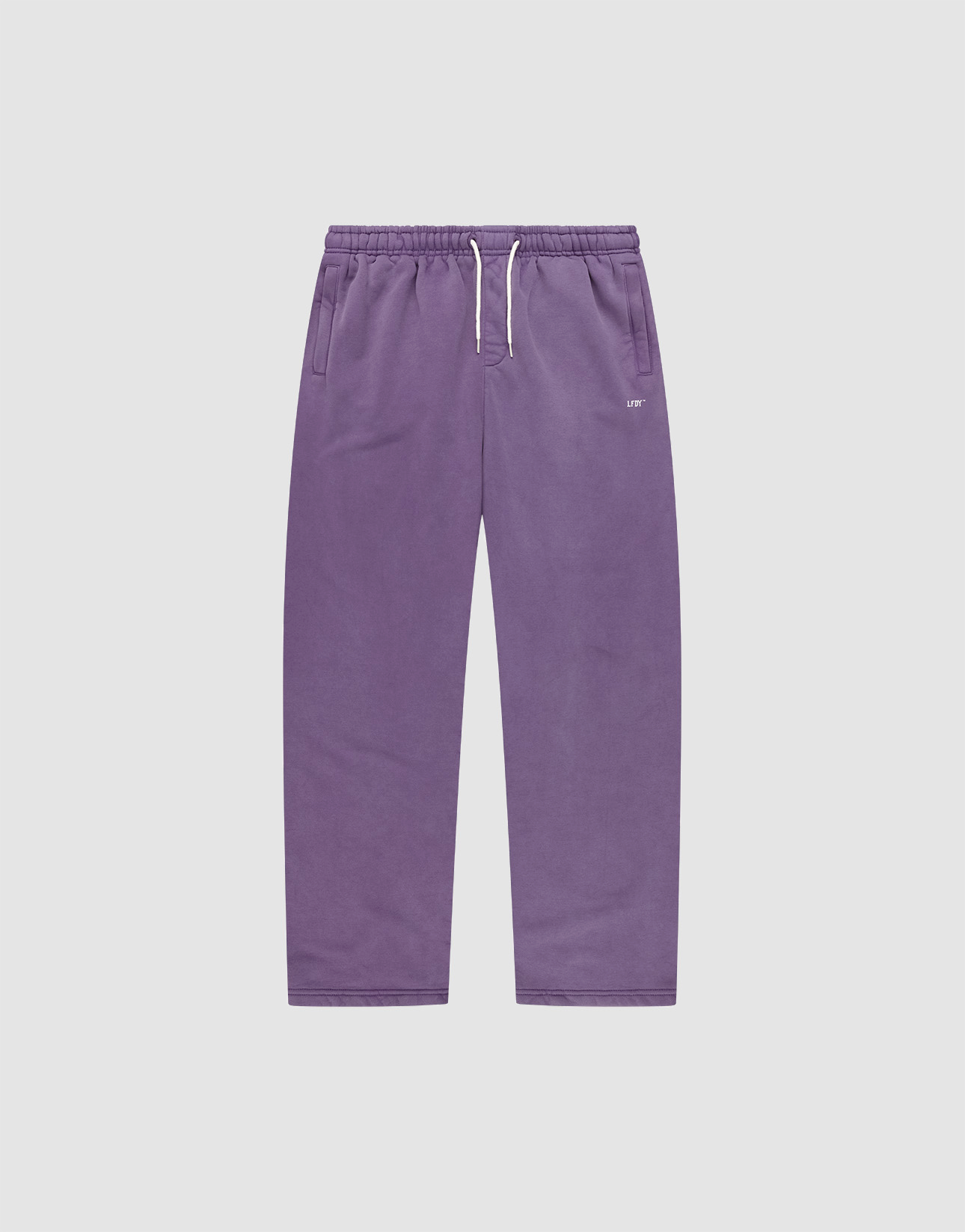 The Basic Wide Jogger by LIVE FAST DIE YOUNG features a purple color, elastic waistband, white drawstring, side pockets, and a relaxed wide fit. Shown laid flat on a plain light grey background. | plain