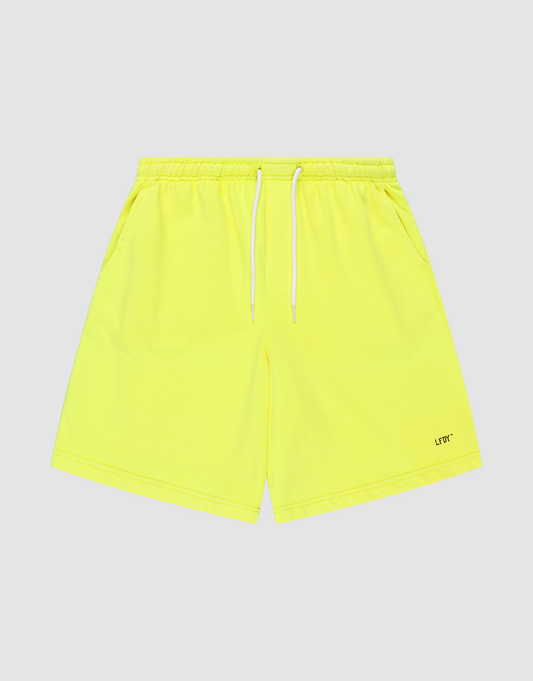 Basic Shorts by LIVE FAST DIE YOUNG in neon yellow, feature an elastischer Bund, white drawstring, side pockets, regular fit, and a small LFTD logo-print near the hem. Displayed on a light grey background. | plain