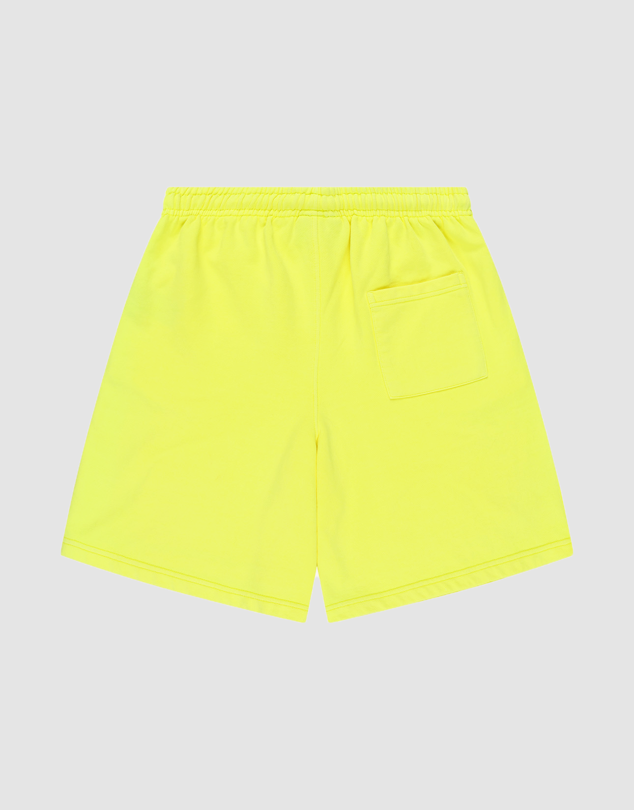 The LIVE FAST DIE YOUNG Basic Shorts are bright yellow with a regular fit, an elastic waistband, and a single back right patch pocket, shown flat on a plain light gray background.