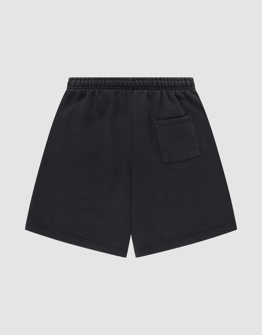 LIVE FAST DIE YOUNG Basic Shorts in black, featuring an elastic waistband and a small patch pocket on the back right. Displayed flat on a light gray background. Regular Fit design for everyday comfort.