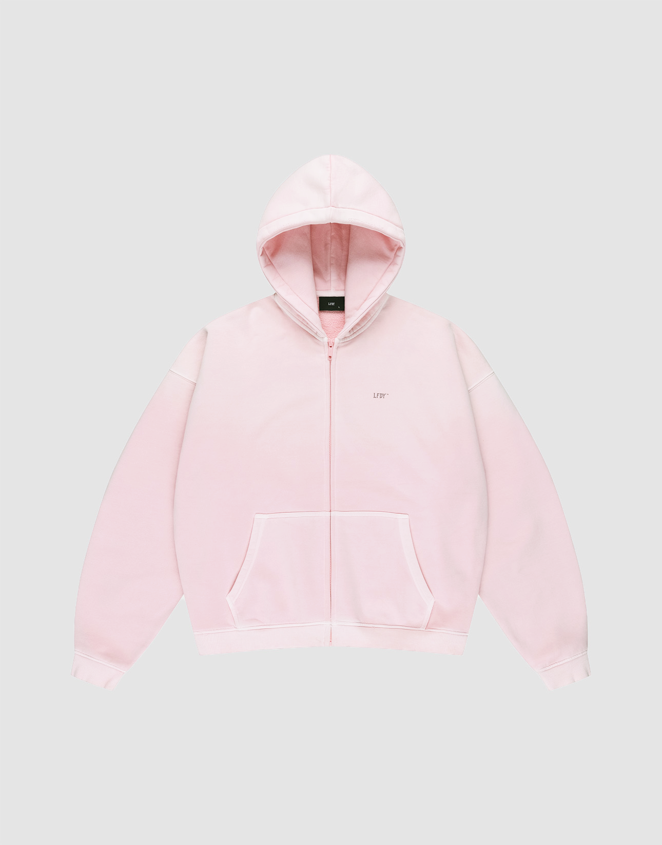 The Basic Evidence Hooded Zip by LIVE FAST DIE YOUNG is a light pink zip-up sweatshirt with a hood, front pockets, a small LIFE logo on the left chest, and subtle LFDY-Branding, shown on a plain light gray background.