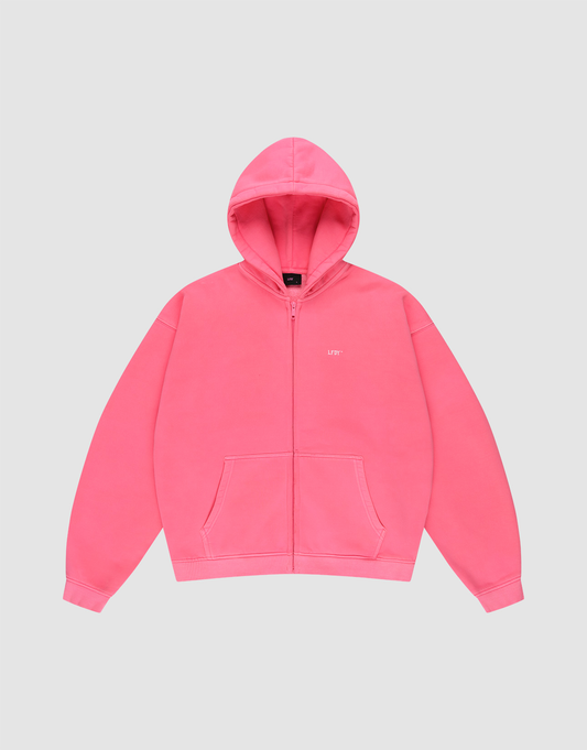 The LIVE FAST DIE YOUNG "Basic Hooded Zip" is a bright pink, oversize-fit zip-up hoodie with front pockets, a hood, and subtle white branding on the left chest, shown against a plain light gray background. | plain