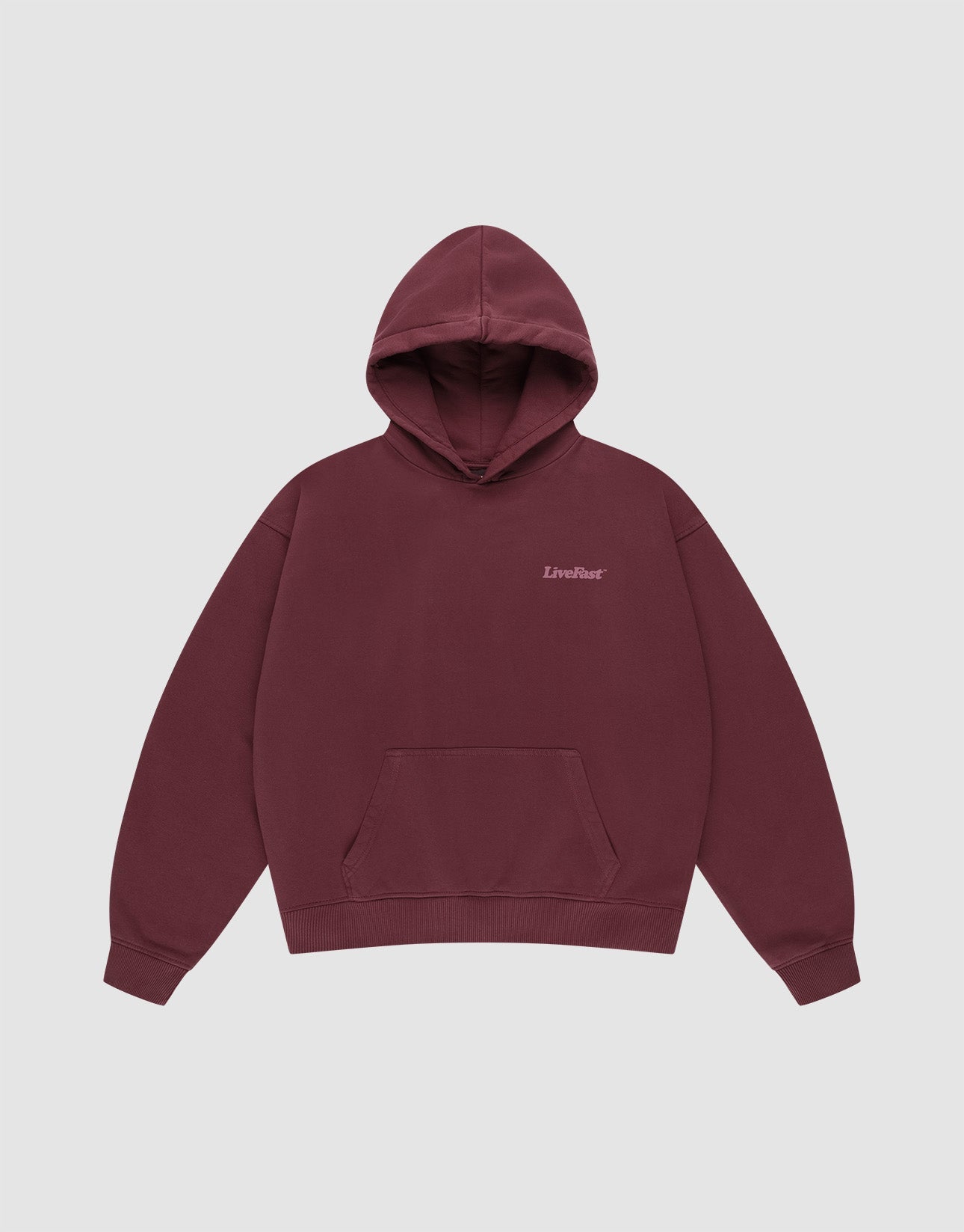 The Basic 360 Hooded by LIVE FAST DIE YOUNG is a maroon cotton hoodie with a front pocket, small "LiveFast" text on the left chest, and an oversize fit, shown against a plain light gray background.
