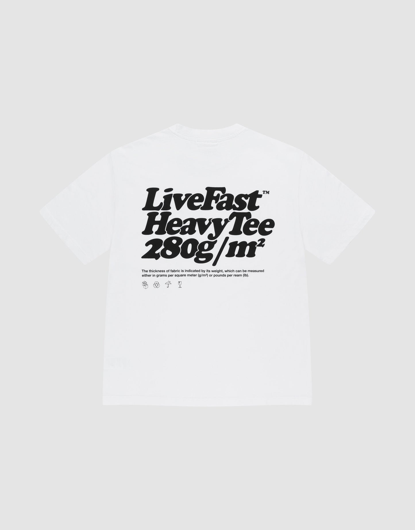 A white Basic 280 Tee by LIVE FAST DIE YOUNG in an oversize fit, made from 100% cotton, features bold black front and back "Live Fast Heavy Tee 280g/m²" prints with smaller text and laundry care symbols underneath.