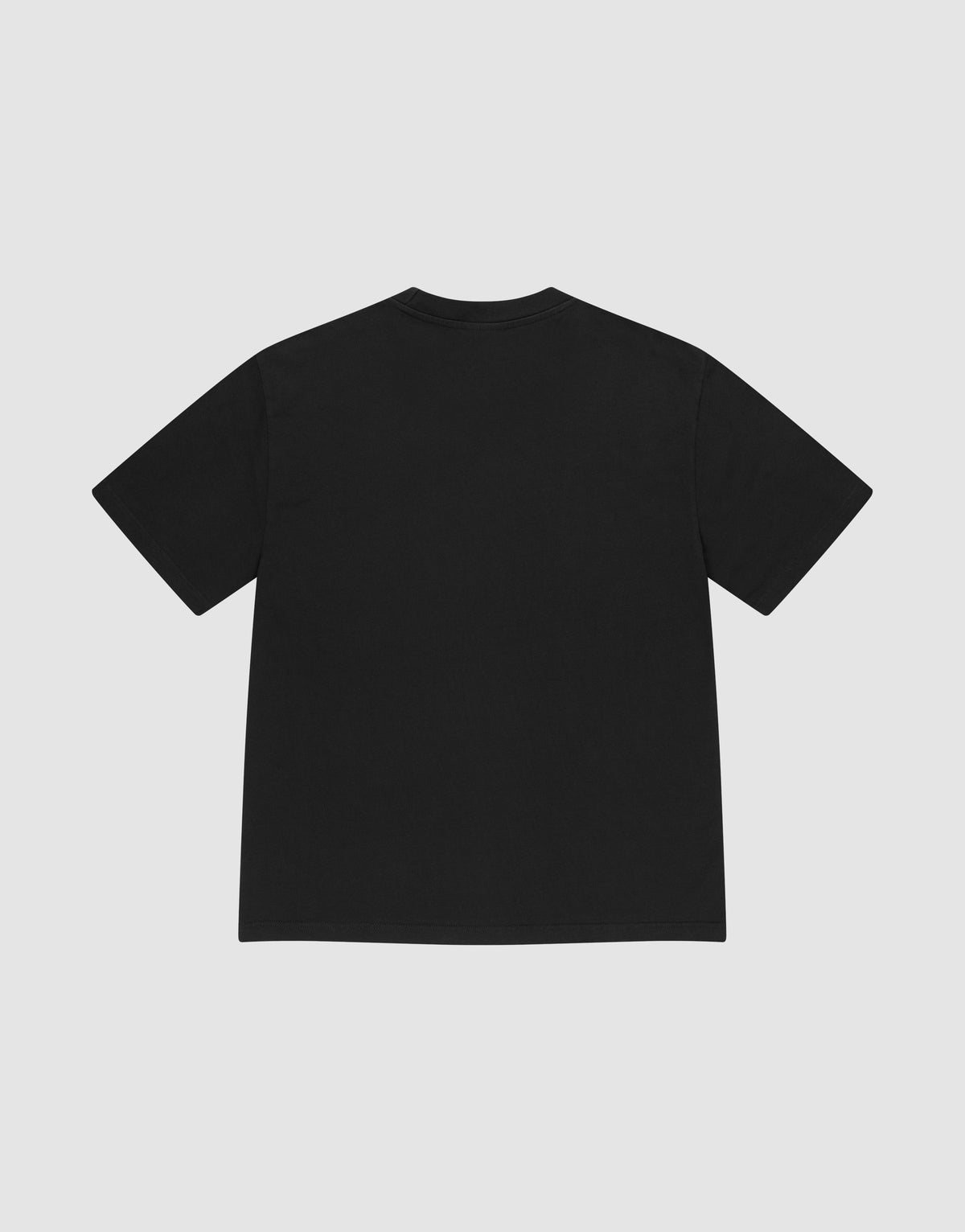 The LIVE FAST DIE YOUNG Basic Heavy Tee, an oversized black short-sleeve t-shirt made from 100% Baumwolle, is shown laid flat with the back facing up on a light gray background, featuring a subtle Flag-Label detail.