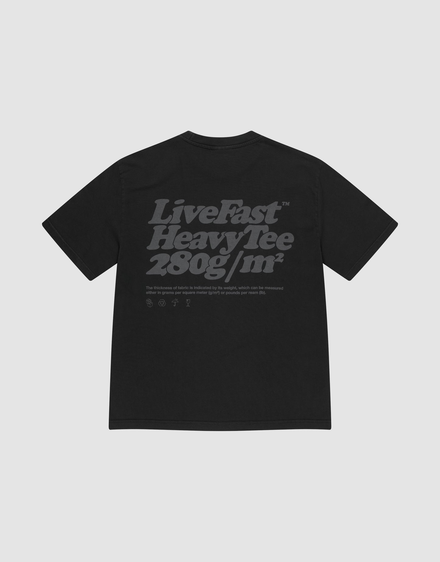 The Basic 280 Tee by LIVE FAST DIE YOUNG is a black oversized t-shirt made from 100% cotton, featuring bold gray "Live Fast Heavy Tee 280g/m²" backprint with smaller text/icons, plus prints on both sides. Shown on a light gray background.