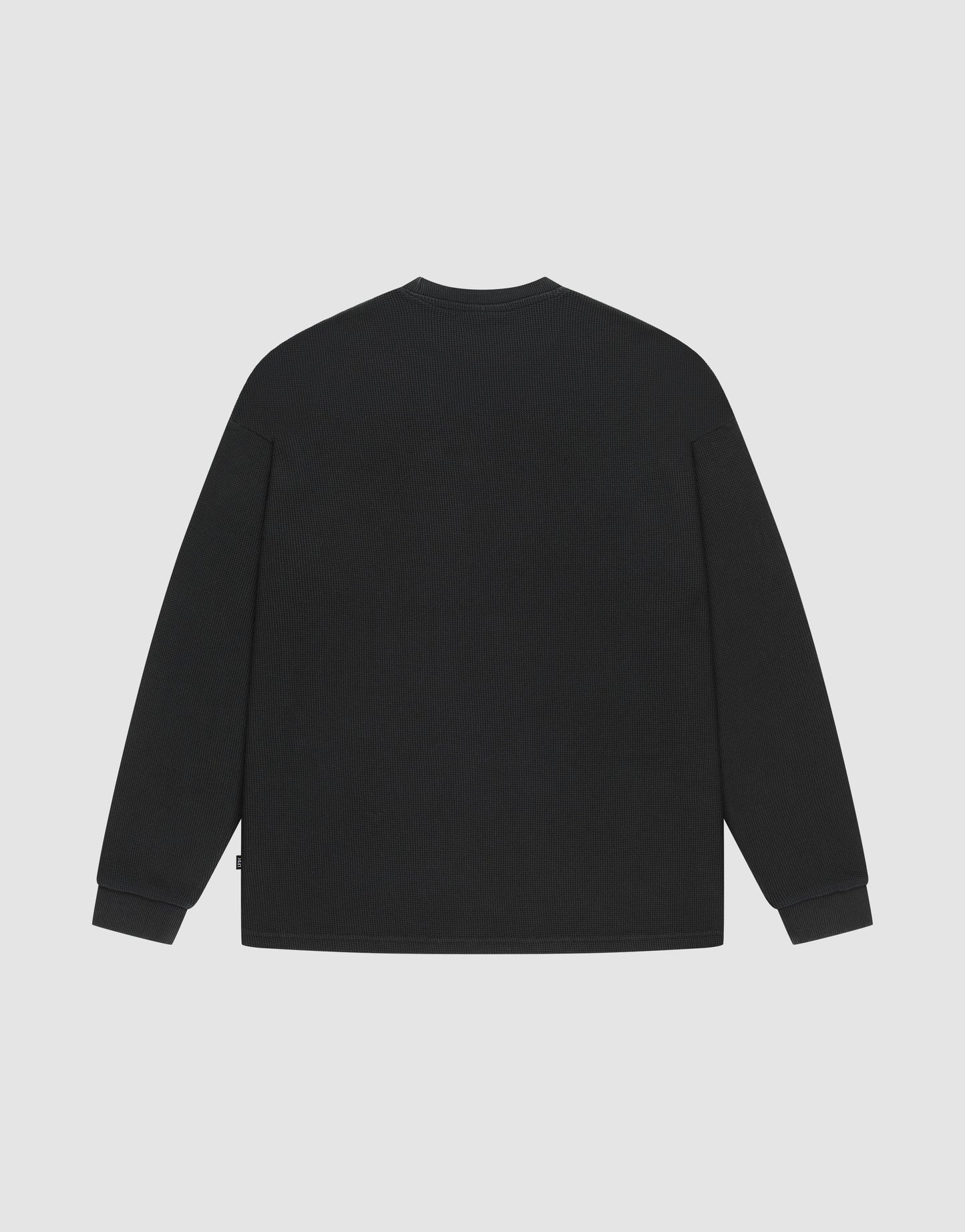 The LIVE FAST DIE YOUNG Blank Waffle Longsleeve is an oversized black shirt with a crew neckline, displayed from the back against a light gray background.