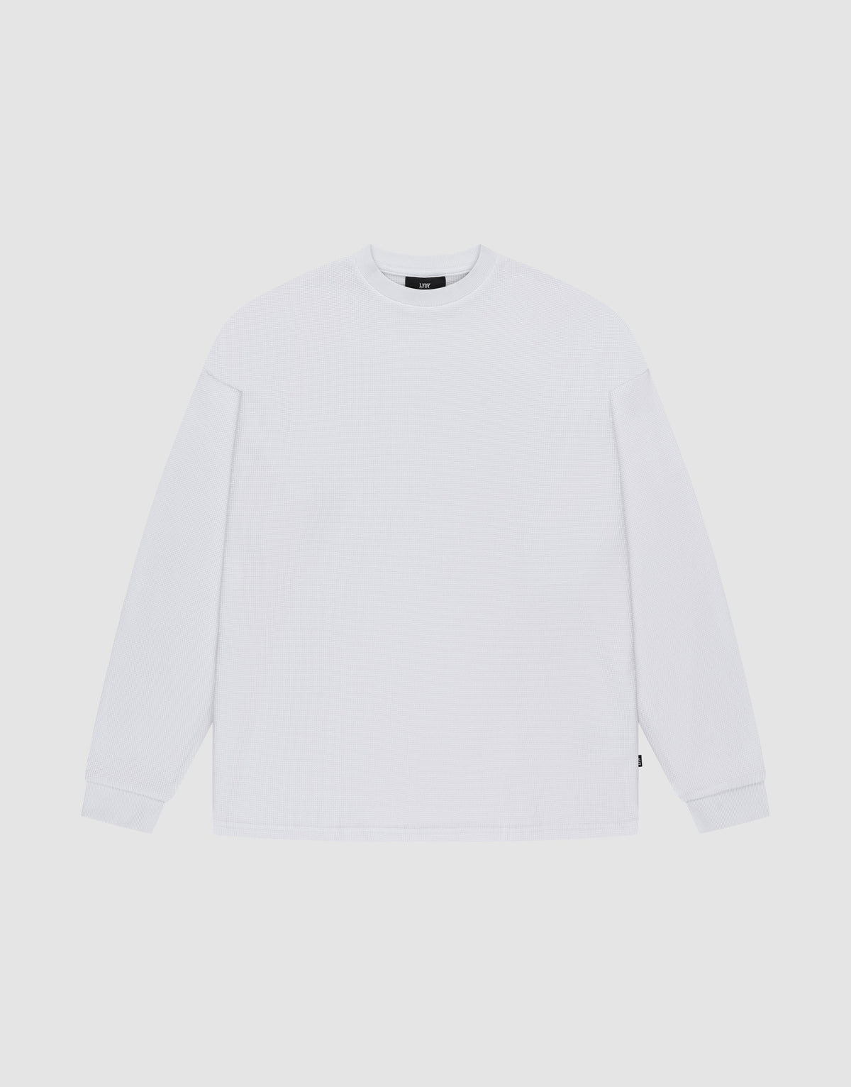 The LIVE FAST DIE YOUNG Blank Waffle Longsleeve, in Oversize Fit, is a plain white crew neck shirt with simple ribbed cuffs, made from 100% Baumwolle and featuring a minimal design without visible logos or patterns. | plain