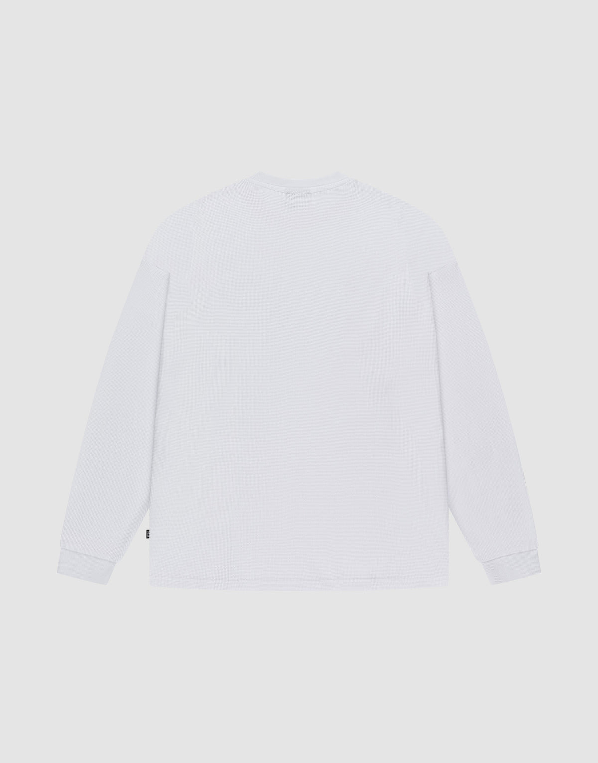 The LIVE FAST DIE YOUNG Blank Waffle Longsleeve is shown flat with the back visible against a light background. Made from 100% Baumwolle, it features an Oversize Fit, crew neckline, and Ripp-Bündchen cuffs for comfort.