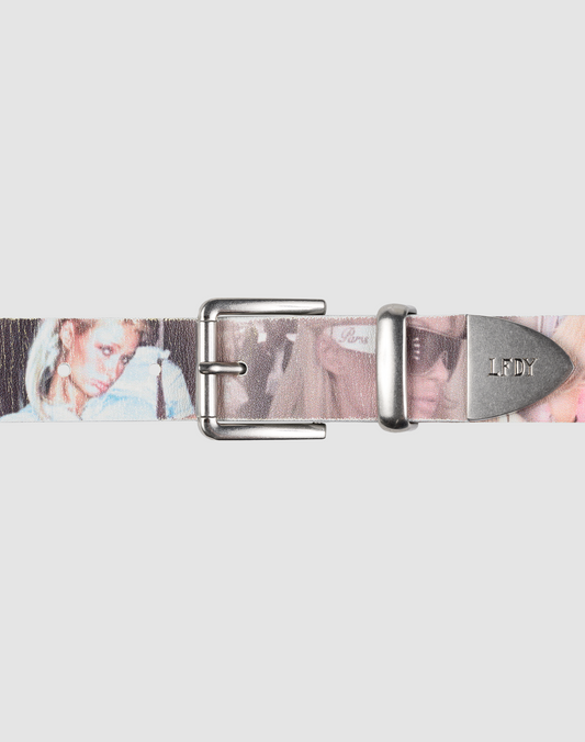 The LFDY Iconic Belt by LIVE FAST DIE YOUNG features printed leather with faded women’s images, a metal buckle, and an LFDY-engraved tip. The light gray background highlights this accessory's unique style. 