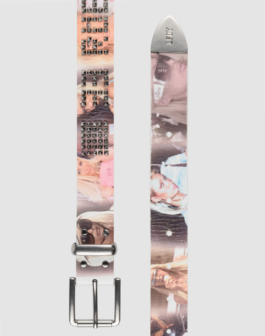 The LFDY Iconic Belt by LIVE FAST DIE YOUNG is a white leather belt with Live Fast studs, repeating photo prints of a blonde woman in various outfits, a silver buckle, and "JXY" printed on the pointed end.