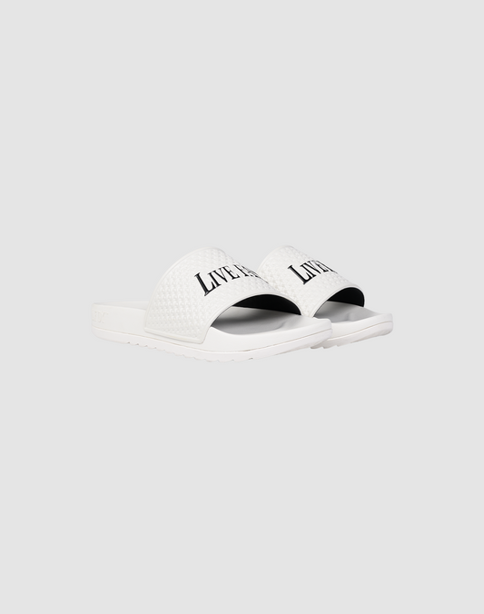 A pair of white LFDY Slides by LIVE FAST DIE YOUNG featuring a textured PU strap with "LIVERPOOL" printed in black, shown on a plain light gray background.