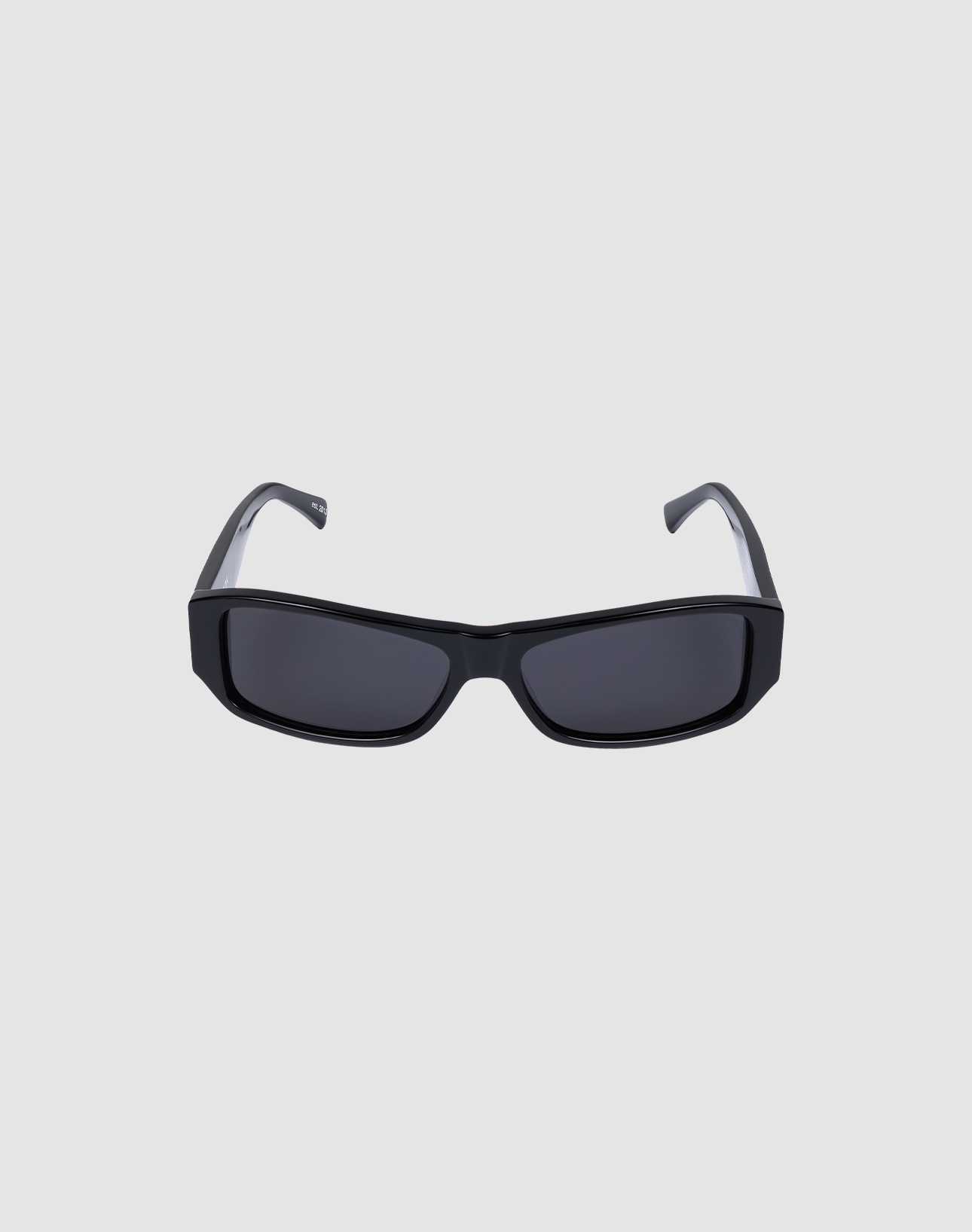 The LFDY Wrap by LIVE FAST DIE YOUNG are rectangular black sunglasses with thick frames and dark lenses offering UV protection, shown on a plain light gray background.