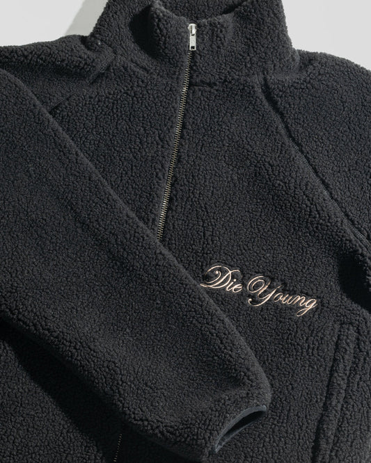 The LFDY Teddy Jacket by LIVE FAST DIE YOUNG is a black oversized jacket with textured fabric, raglan sleeves, a zipper, and “Die Young” embroidered in cursive on the front.