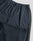 Close-up of the LFDY Striped Jogger by LIVE FAST DIE YOUNG in navy blue with elastic waistband, side zipper pocket, and dark gray side panels, laid flat on a light gray background.
