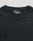 Close-up of a plain black LFDY Slim Tee by LIVE FAST DIE YOUNG, lying flat to reveal the upper chest and neckline. A black label with "LFDY" text is visible inside the collar. The shirt is crafted from soft cotton.