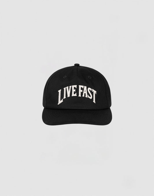 The Live Fast Unstructured Cap by LIVE FAST DIE YOUNG is a black baseball cap featuring a Flag Label and bold white LIVE FAST Logo-Stick embroidery on the front, shown against a plain light gray background. 