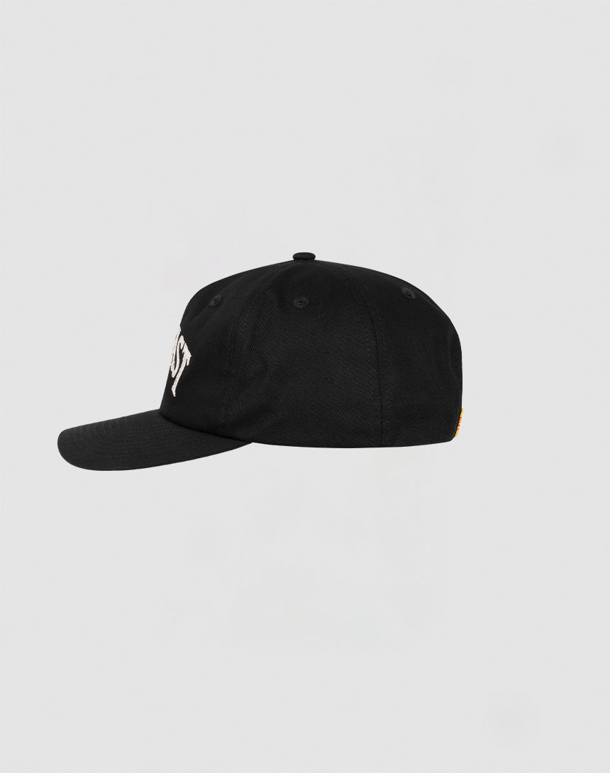 The Live Fast Unstructured Cap by LIVE FAST DIE YOUNG is a black baseball cap with a curved brim, side view, and white embroidered front text. Features include Mit Snapverschluss and a Flag Label, shown against a light gray background.