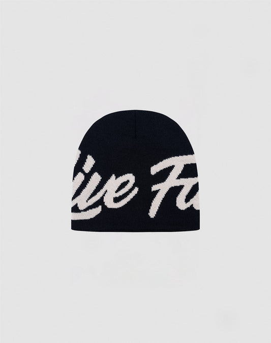 The LFDY Jacquard Beanie by LIVE FAST DIE YOUNG features bold white cursive branding on black Polyacryl knit, with the logo partially visible against a plain light gray background.| plain 
