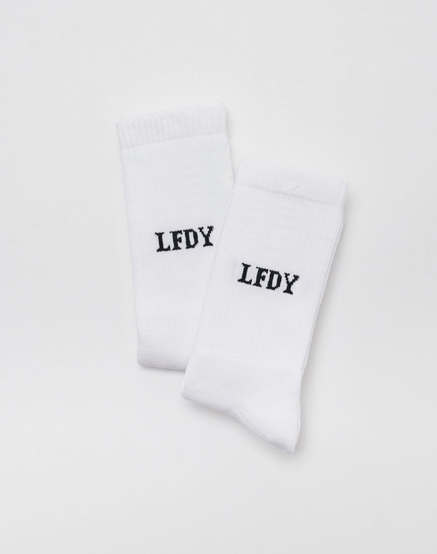 The LFDY Logo Socks (2 Pack) by LFDY are shown side by side on a plain white background. Both socks feature LFDY printed in bold black uppercase letters near the top and are made from a soft Baumwolle-Elastan-Polyamid blend.| plain 