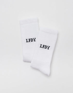 The LFDY Logo Socks (2 Pack) by LFDY are shown side by side on a plain white background. Both socks feature LFDY printed in bold black uppercase letters near the top and are made from a soft Baumwolle-Elastan-Polyamid blend. 