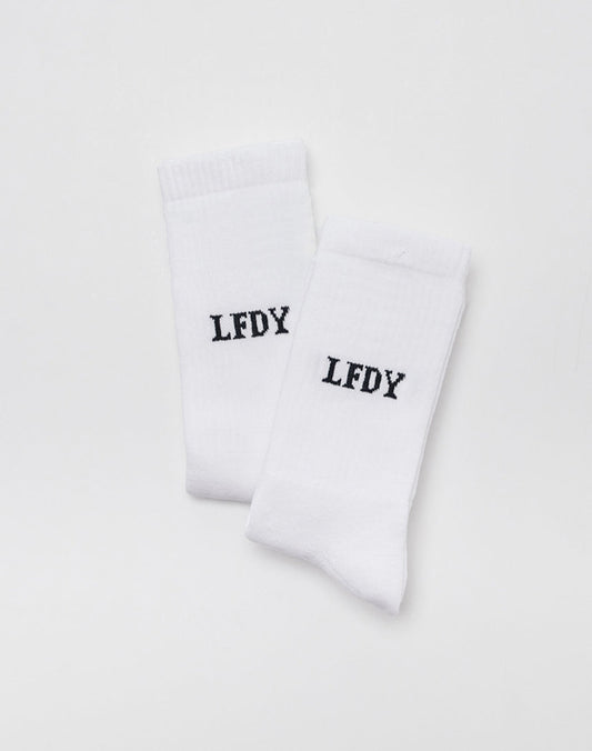 The LFDY Logo Socks (2 Pack) by LFDY are shown side by side on a plain white background. Both socks feature LFDY printed in bold black uppercase letters near the top and are made from a soft Baumwolle-Elastan-Polyamid blend.
