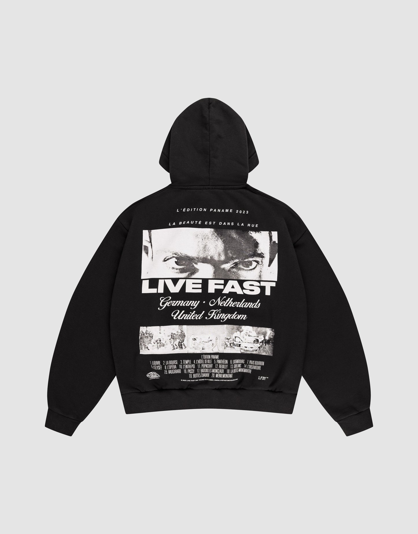 The LFDY Cinema Hooded by LIVE FAST DIE YOUNG is an oversized black cotton hoodie with intense eyes and "LIVE FAST" printed on the front, plus Germany, Netherlands, United Kingdom text and a cityscape image on the back.