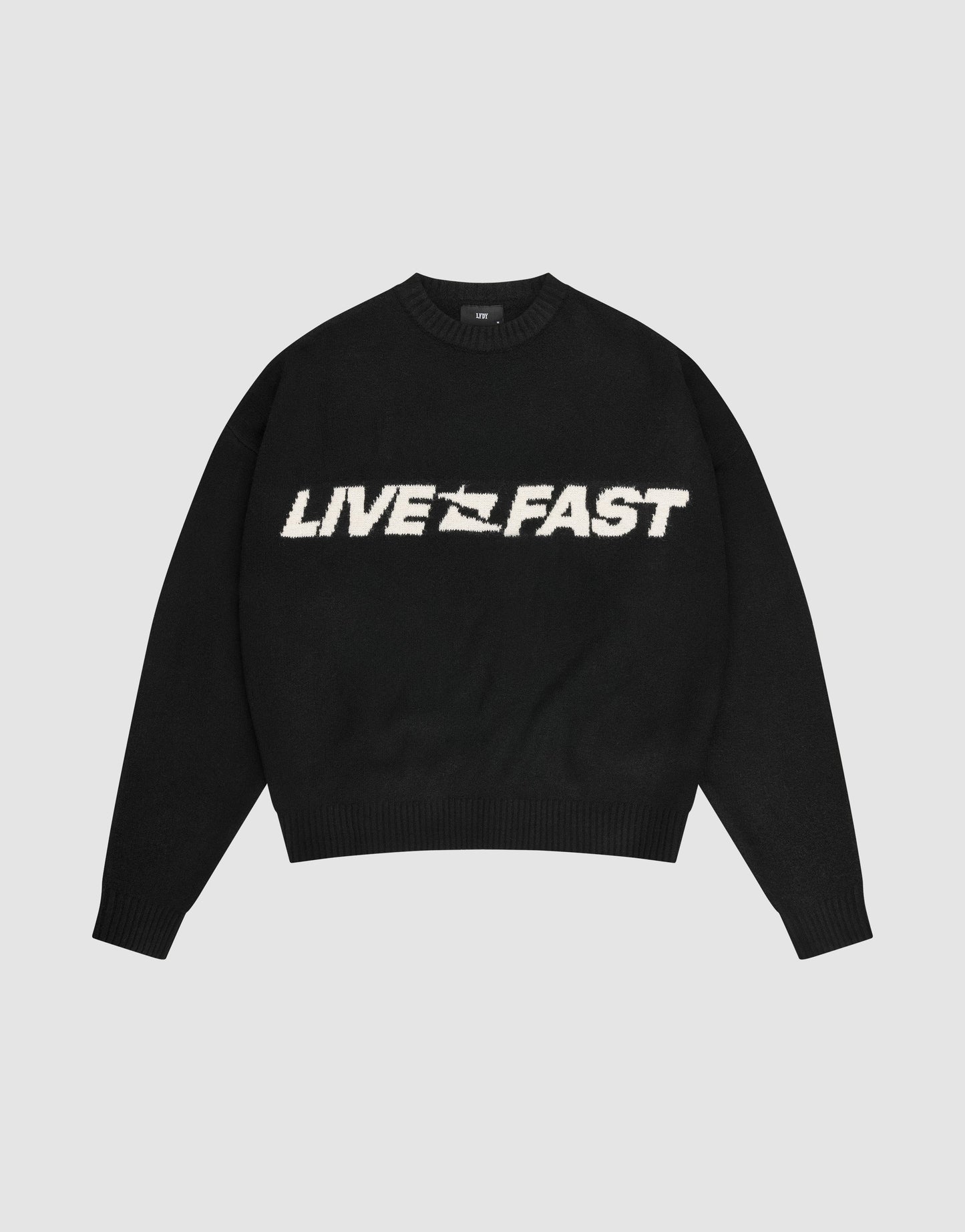 The Live Fast Boucle Sweater by LIVE FAST DIE YOUNG is a black oversized crewneck with "LIVE FAST" in bold white lettering across the chest.