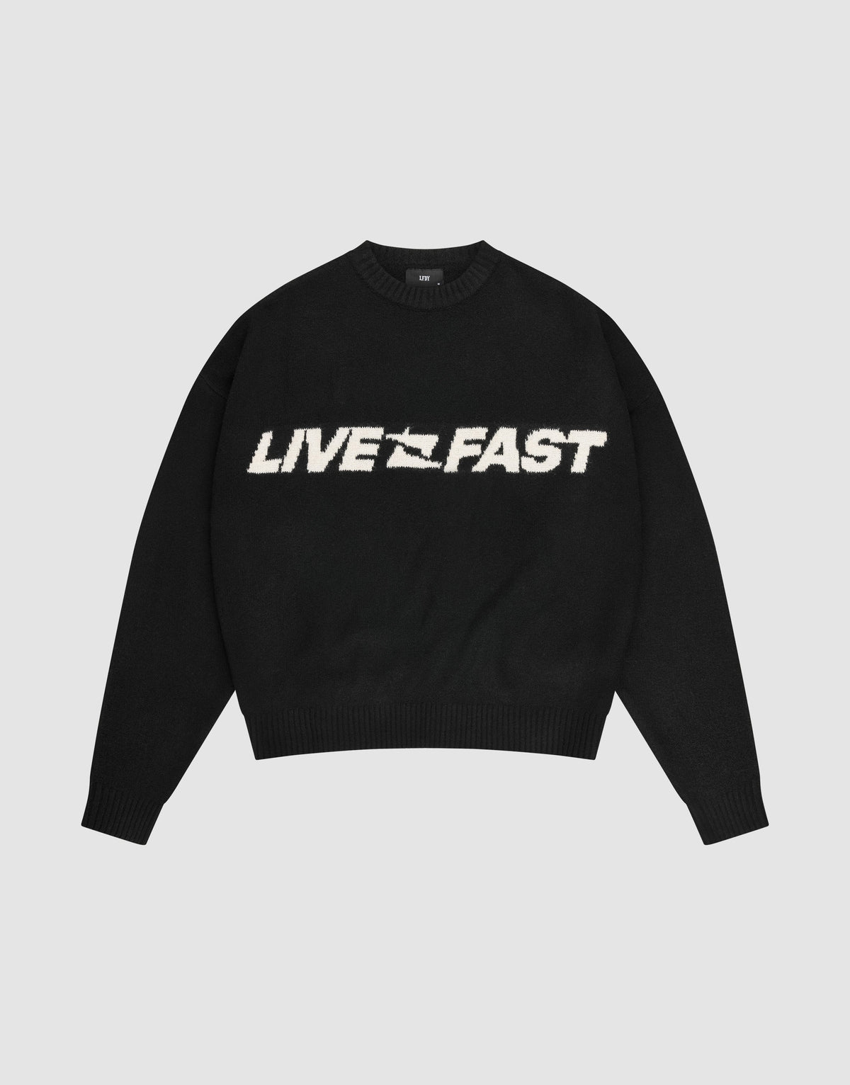 The Live Fast Boucle Sweater by LIVE FAST DIE YOUNG is a black oversized crewneck with "LIVE FAST" in bold white lettering across the chest. | plain