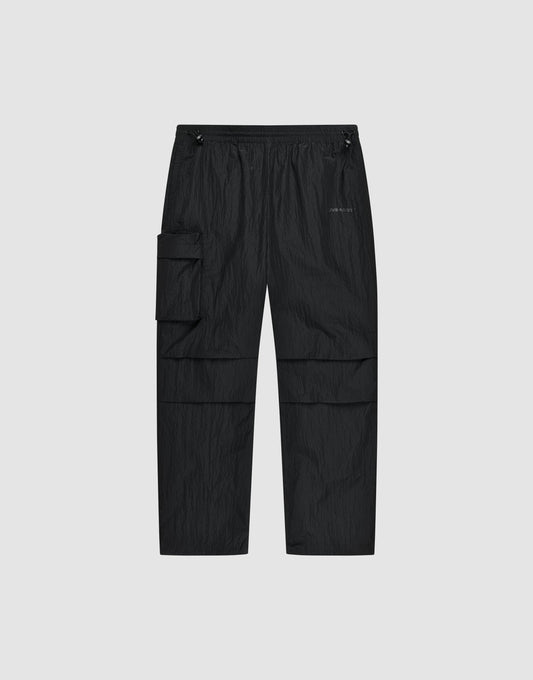 The Live Fast Nylon Pants by LIVE FAST DIE YOUNG feature an elastic waistband, adjustable drawstrings, oversized fit, multiple pockets including a large zip cargo pocket, and a small logo on the left thigh, shown against a light gray background. | plain