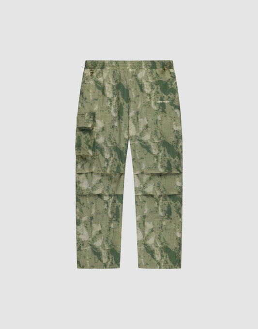 LIVE FAST DIE YOUNG Live Fast Nylon Pants in green camouflage, featuring an oversize fit, multiple cargo pockets, elastic waistband, and zipper, shown flat on a plain light background. | plain