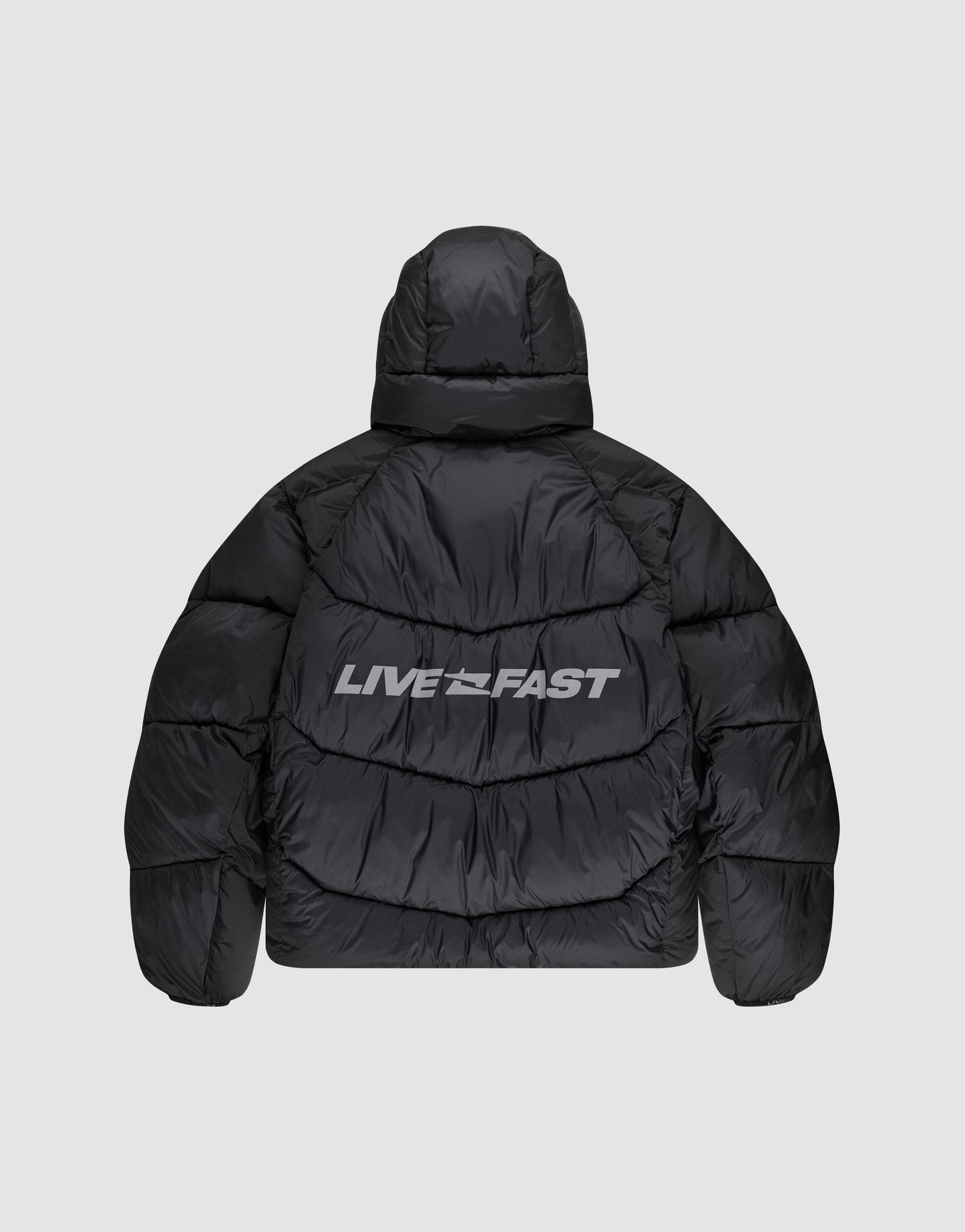 The Live Fast Puffer Jacket by LIVE FAST DIE YOUNG features a black oversize fit, hood, and bold white "LIVE FAST" reflektierender Print across the upper back for standout style.