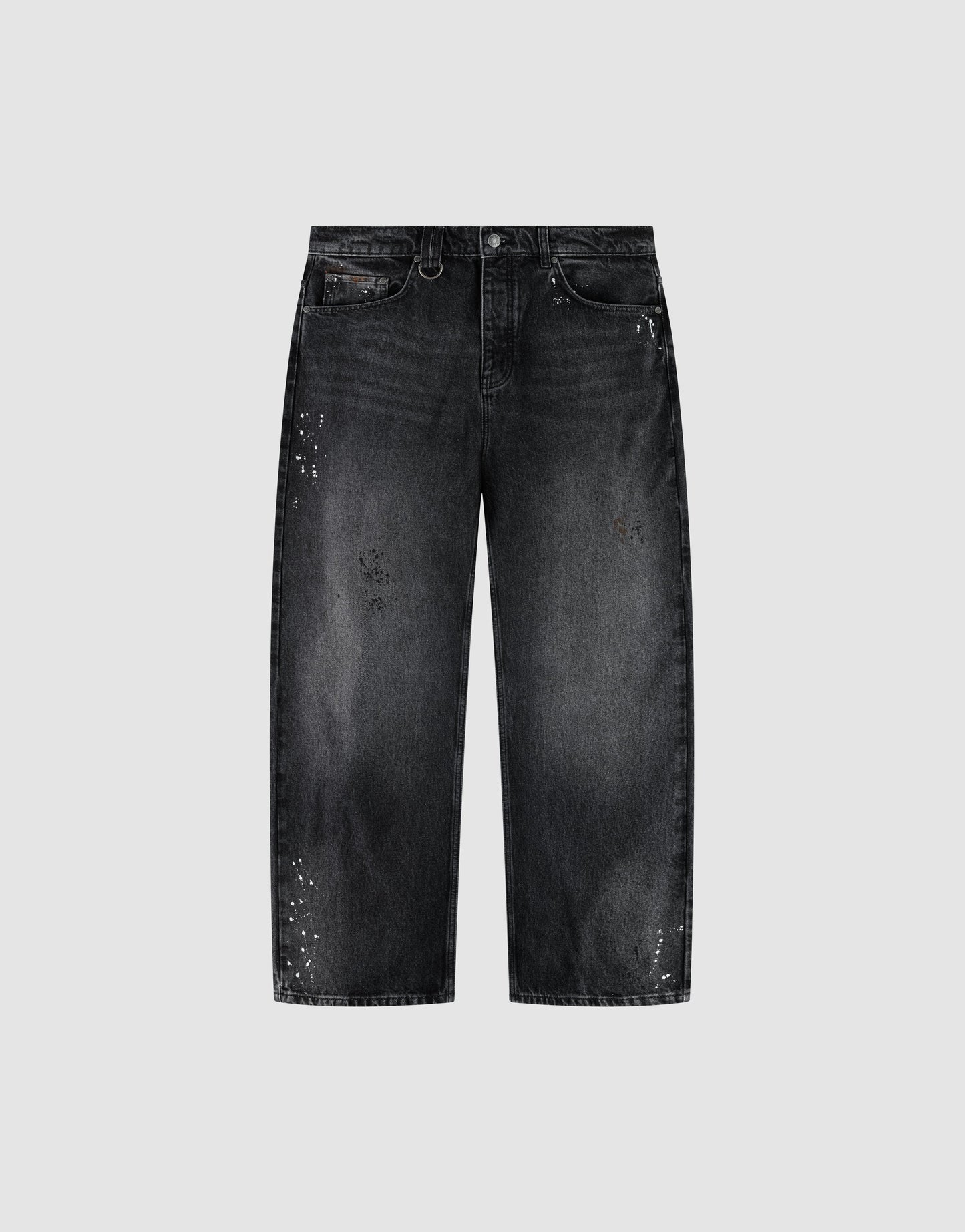 The LIVE FAST DIE YOUNG LFDY Baggy Denim is a pair of black jeans with a wide straight leg, baggy fit, faded wash, and white paint splatters, shown on a plain light gray background. | plain