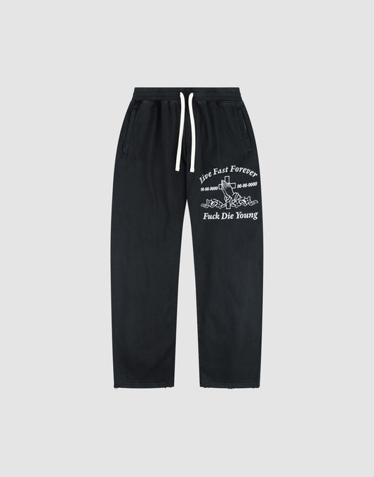 The LFDY Praying Jogger by LIVE FAST DIE YOUNG features a wide fit, white drawstrings, and bold white graphic text with a snake illustration on the left thigh. | plain