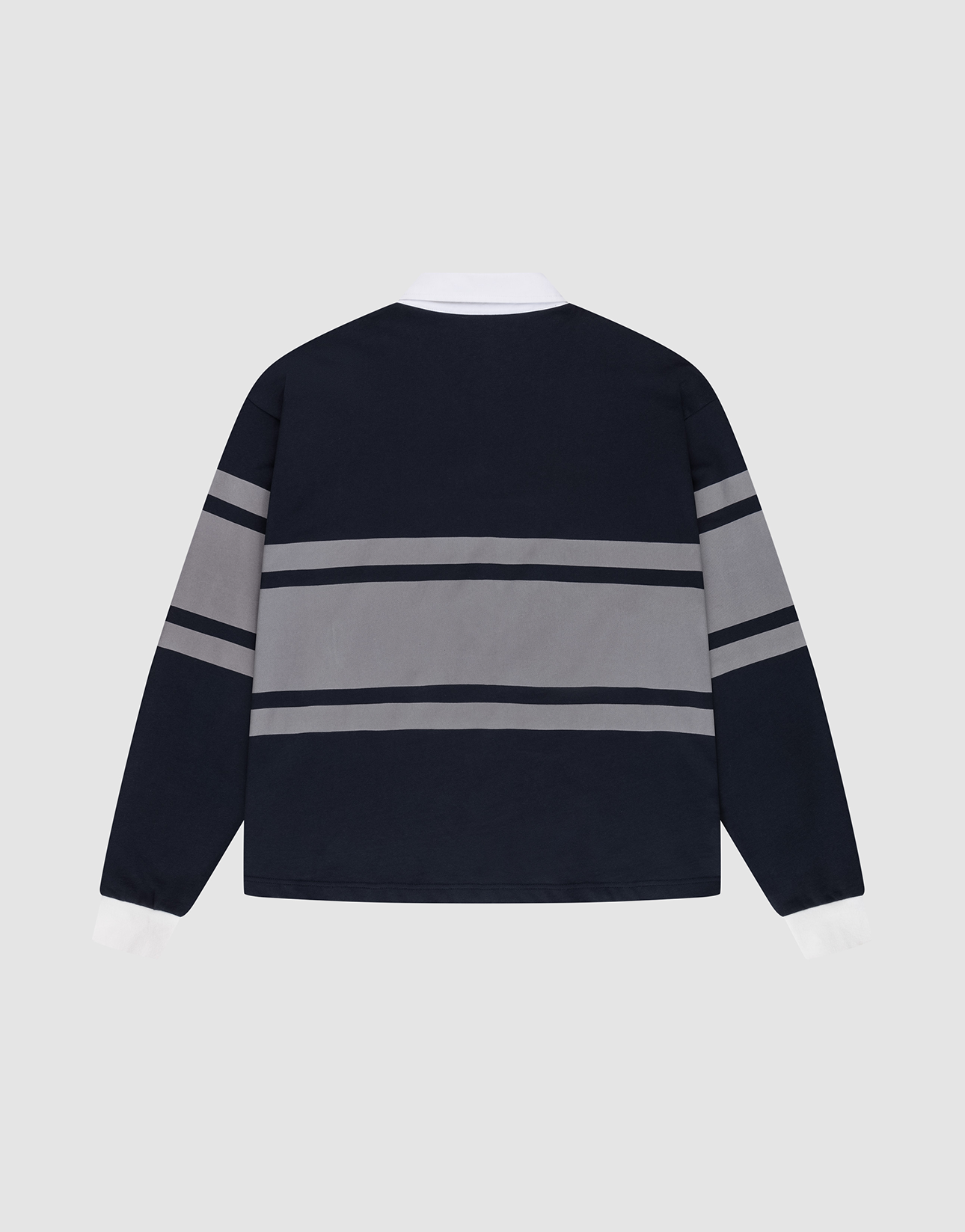 The LFDY Striped Polo by LIVE FAST DIE YOUNG is a navy blue oversize fit long-sleeve shirt with white cuffs and collar, featuring two grey stripes across the back and sleeves. Made from soft cotton twill, it's displayed flat on a light gray background.