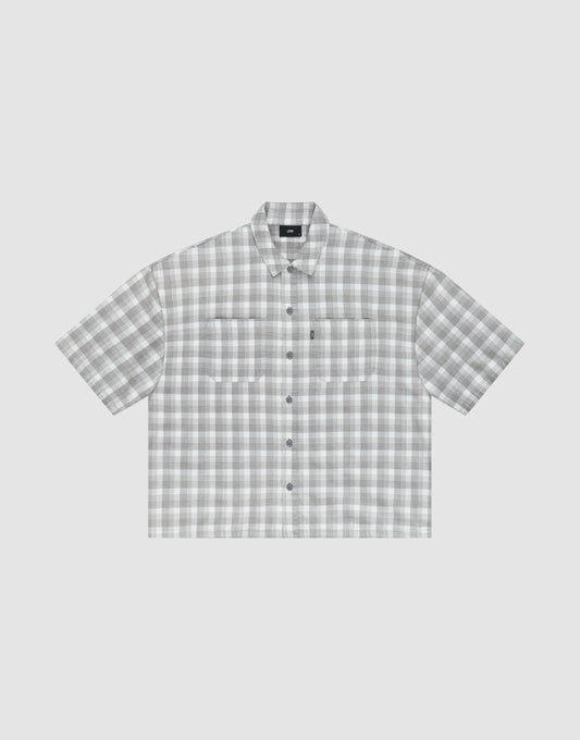 The LIVE FAST DIE YOUNG LFDY Light Flannel is an oversize fit, short-sleeved button-up with gray and white plaid, two chest pockets, and a pointed collar, shown on a plain light background. | plain