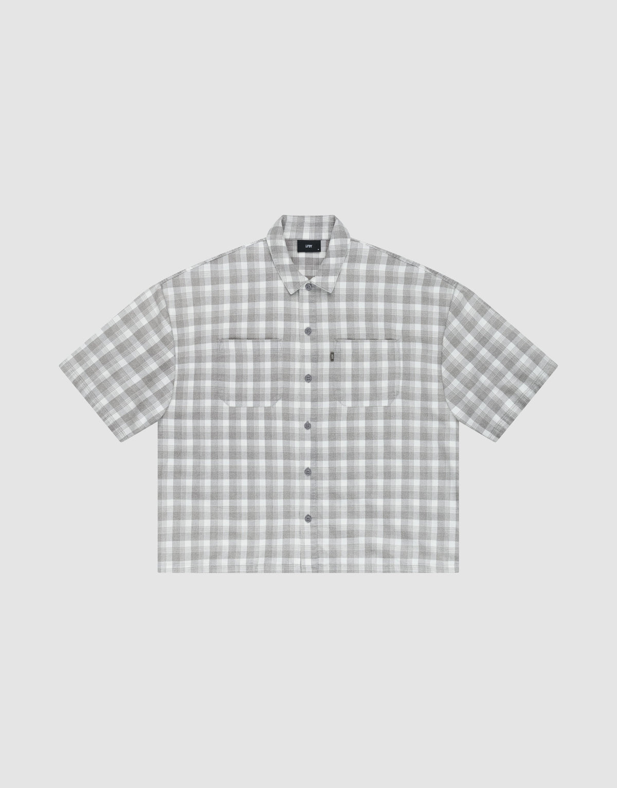 The LIVE FAST DIE YOUNG LFDY Light Flannel is an oversize fit, short-sleeved button-up with gray and white plaid, two chest pockets, and a pointed collar, shown on a plain light background. | plain