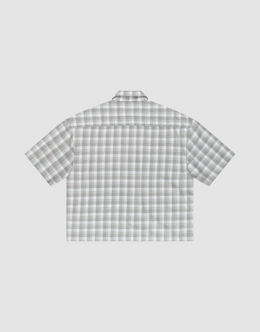 The LIVE FAST DIE YOUNG LFDY Light Flannel is a short-sleeve, button-up shirt shown flat with its back up, featuring a gray and white plaid design, straight hem, and relaxed oversize fit.