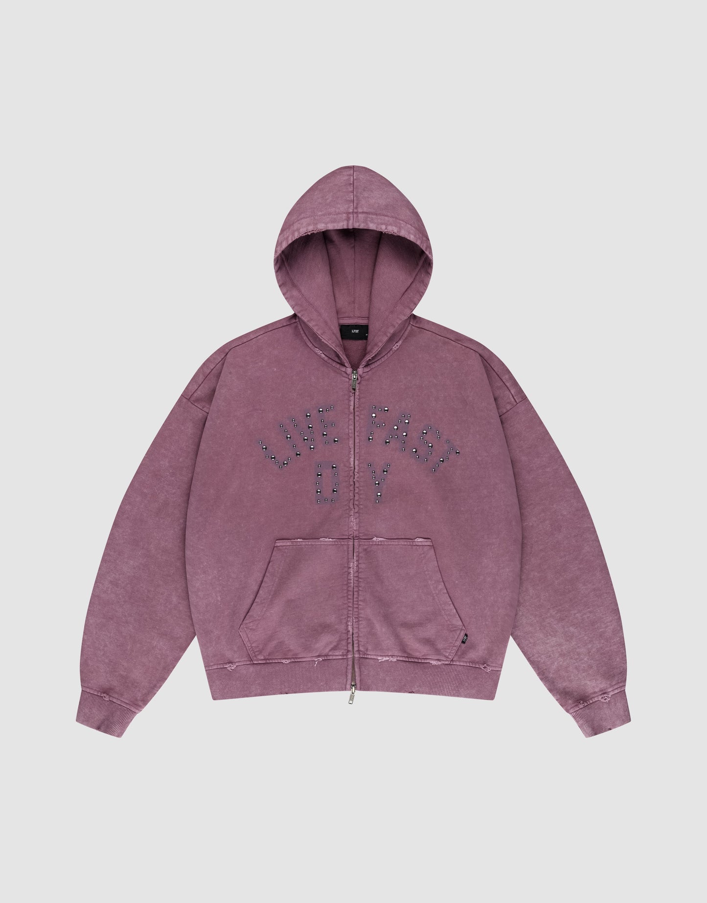 The LIVE FAST DIE YOUNG Live Fast Rivet Hooded Zip is a purple, oversized hoodie with a zip front, hood, and front pockets. "LIVE FAST OY" is boldly printed in dotted letters on the chest. Features a vintage faded look with subtle distressing.