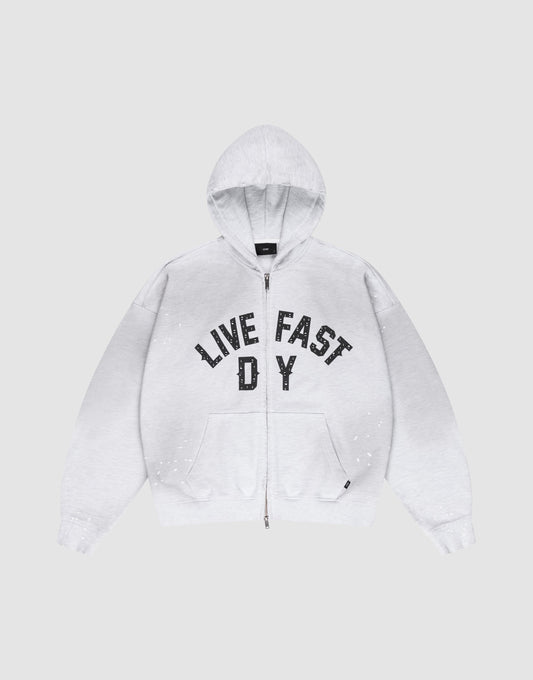 The Live Fast Rivet Hooded Zip by LIVE FAST DIE YOUNG is a light gray, oversize-fit hoodie with front pockets, a hood, black “LIVE FAST D Y” chest text, and unique hand-applied white paint splatters. Made from 100% Baumwolle. | plain