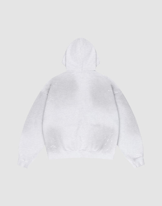 The LIVE FAST DIE YOUNG Live Fast Rivet Hooded Zip in light gray is laid flat, back up, on a matching background. It features an oversize fit and hand-applied spray effect with scattered white specks.