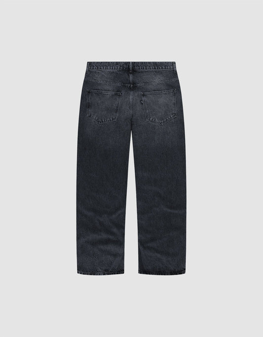 Back view of the LFDY Baggy Denim by LIVE FAST DIE YOUNG, crafted from 100% Baumwolle in dark-wash with a wide straight leg, two back pockets, no visible distressing, shown on a plain light gray background.
