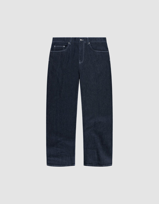 The LFDY Baggy Denim by LIVE FAST DIE YOUNG features dark blue raw-denim, a baggy straight-leg fit, white stitching, five pockets, and button closure in 100% cotton. Shown on a plain light grey background. | plain