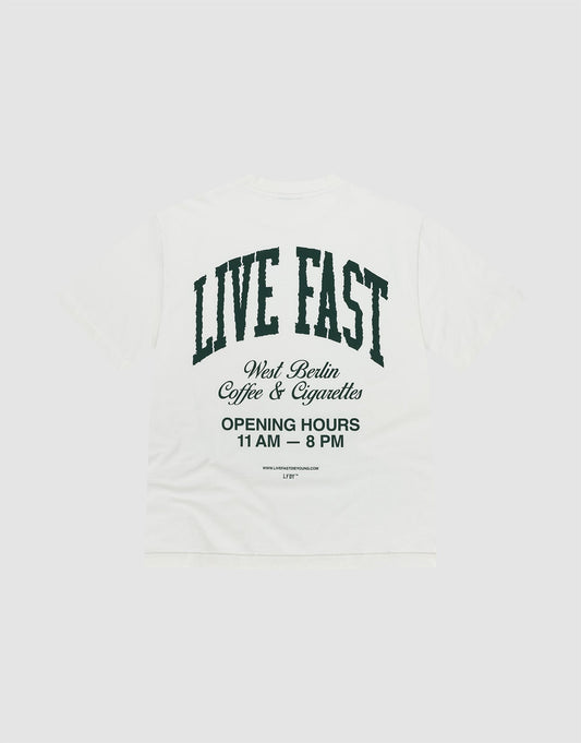 The Live Fast Coffee Tee by LIVE FAST DIE YOUNG is a white oversized T-shirt made from 100% Baumwolle, featuring bold front and back prints. Large black text on the back reads "LIVE FAST" with West Berlin Coffee & Cigarettes and opening hours below. | plain